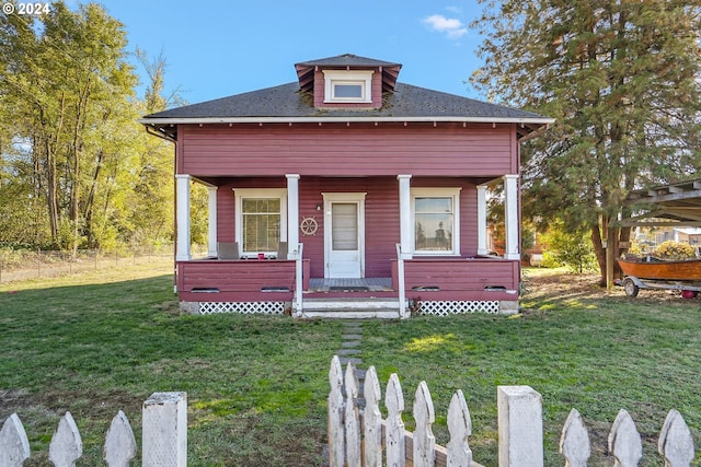 bungalow featuring a porch and a front lawn