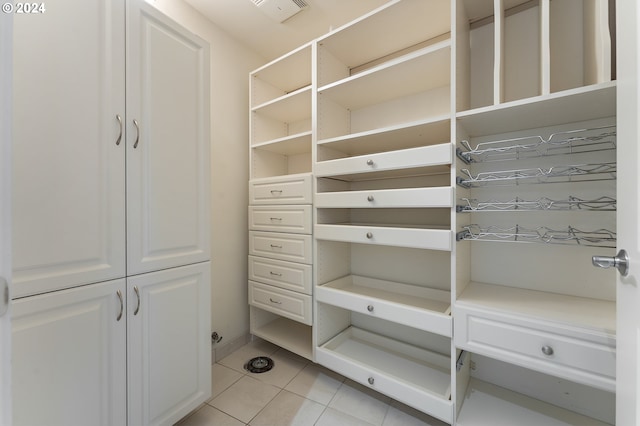 spacious closet with light tile patterned floors