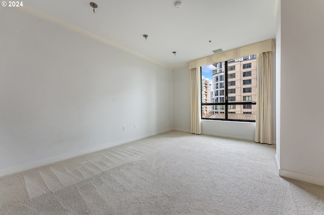 carpeted empty room featuring ornamental molding