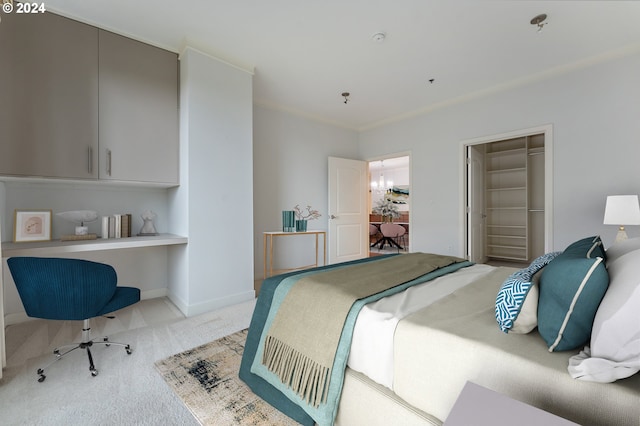 bedroom with a notable chandelier, a spacious closet, light carpet, and a closet