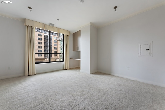 carpeted empty room featuring ornamental molding and electric panel