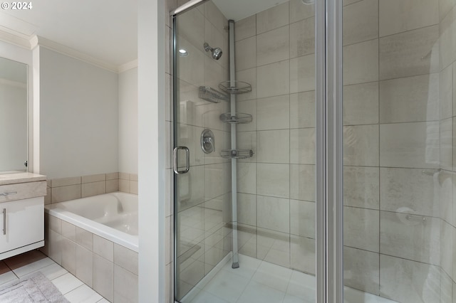 bathroom featuring tile patterned floors, crown molding, vanity, and independent shower and bath