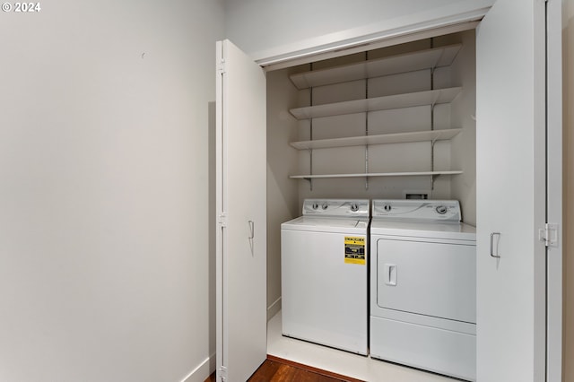 laundry room featuring dark hardwood / wood-style flooring and washing machine and clothes dryer