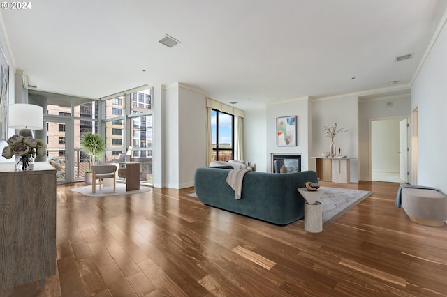 living room featuring floor to ceiling windows, crown molding, plenty of natural light, and dark hardwood / wood-style floors