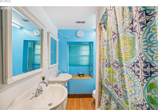 bathroom featuring sink, hardwood / wood-style floors, and toilet