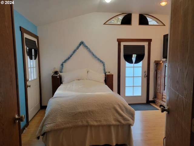 bedroom featuring light hardwood / wood-style flooring and vaulted ceiling