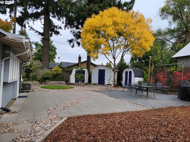 exterior space featuring central air condition unit, a patio, and a shed