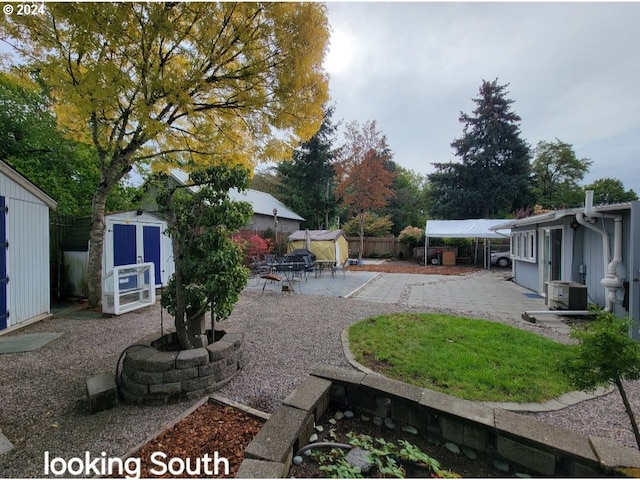 view of yard featuring a patio, a shed, and cooling unit