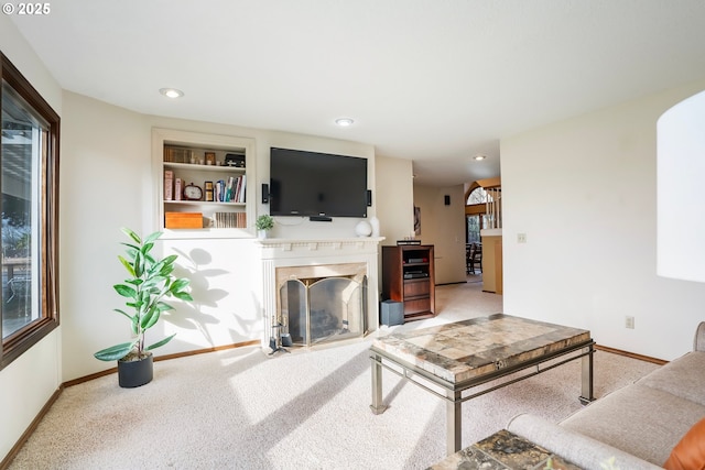 carpeted living room with built in features