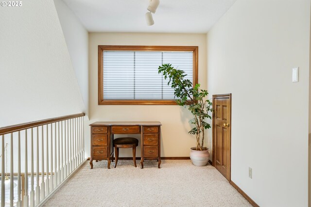 hall featuring carpet floors and an inviting chandelier