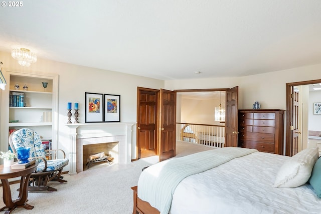 bedroom with connected bathroom, carpet floors, and a notable chandelier