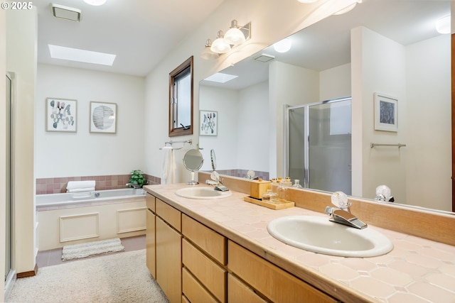 bathroom featuring separate shower and tub, a skylight, and vanity