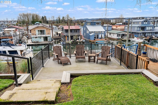 wooden terrace with a yard and a water view