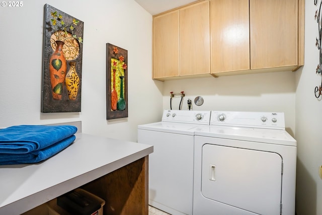 washroom with washing machine and dryer and cabinets