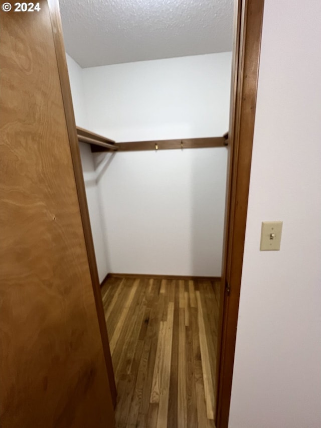 spacious closet featuring hardwood / wood-style floors