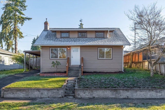 bungalow with a front yard and a carport