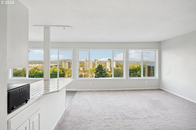 unfurnished sunroom with a city view