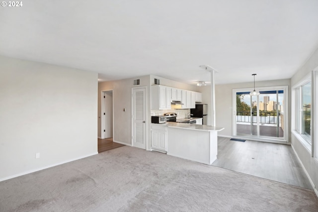 kitchen featuring decorative light fixtures, tasteful backsplash, white cabinetry, stainless steel appliances, and a peninsula