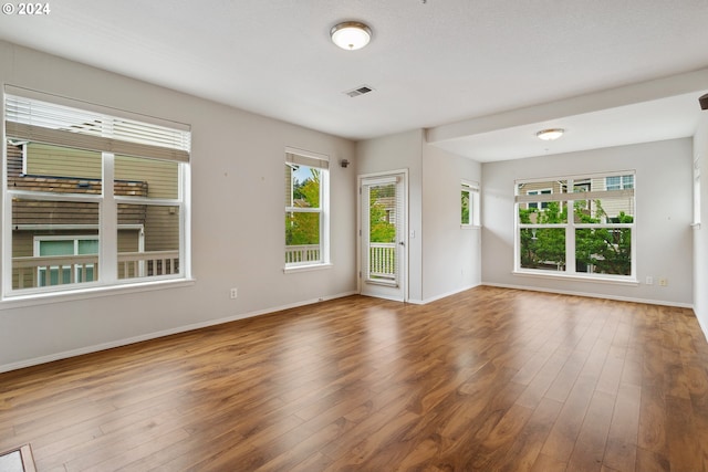 unfurnished room with wood-type flooring