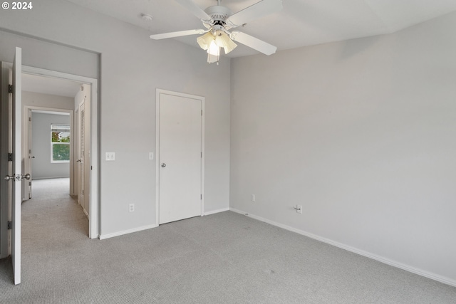 unfurnished bedroom with ceiling fan and light carpet