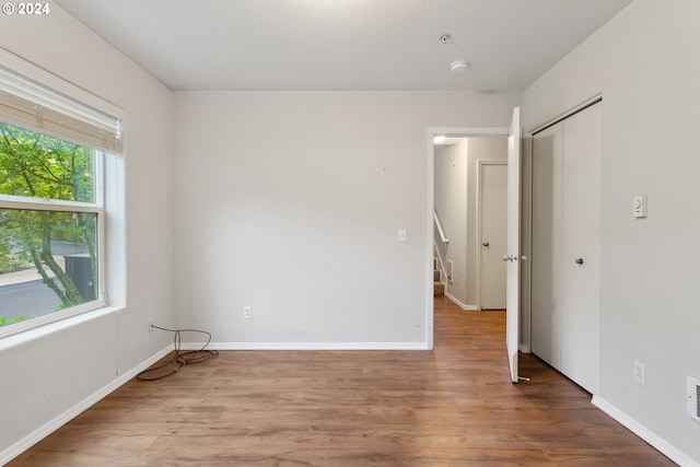 unfurnished room featuring hardwood / wood-style flooring