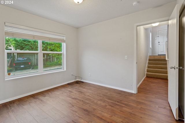 unfurnished room with wood-type flooring