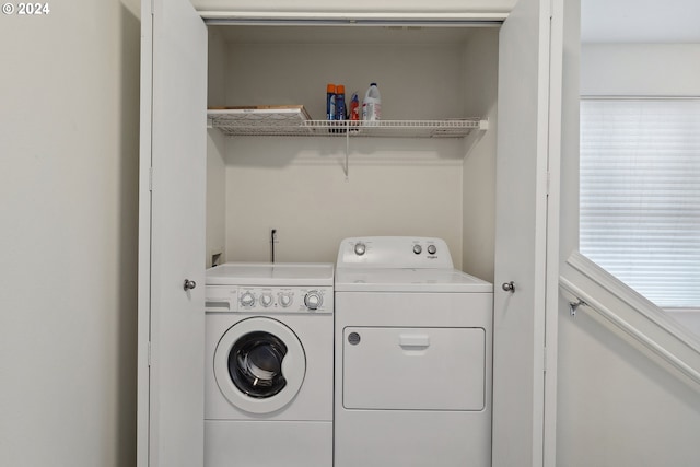 laundry room with washing machine and clothes dryer