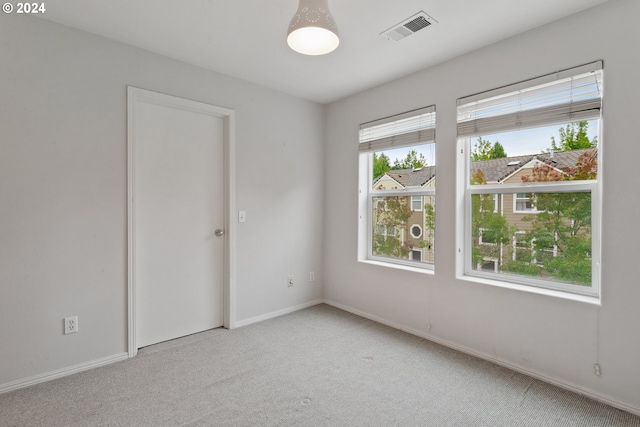 spare room with light colored carpet