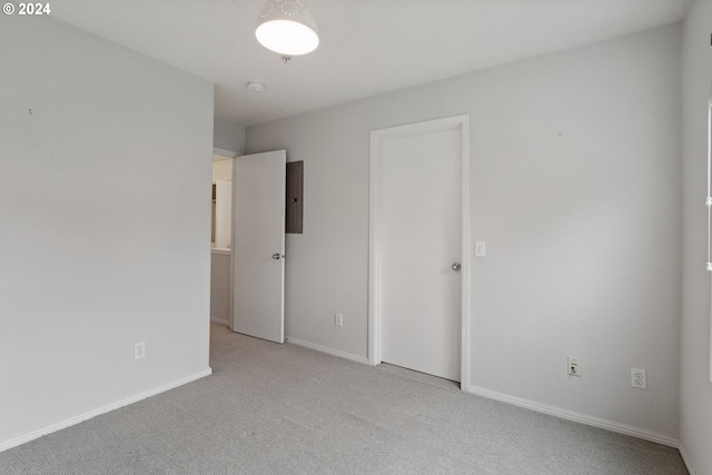 carpeted empty room with electric panel