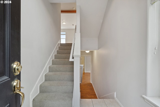 stairway featuring tile patterned flooring