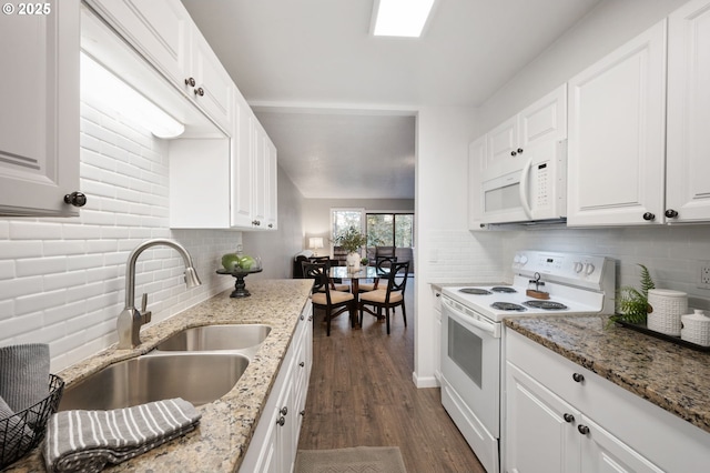 kitchen featuring sink, white cabinetry, light stone counters, white appliances, and dark hardwood / wood-style flooring