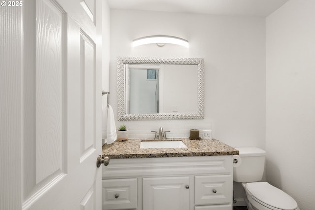 bathroom with toilet and vanity