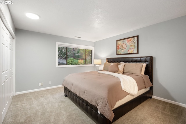 bedroom with a closet and light carpet