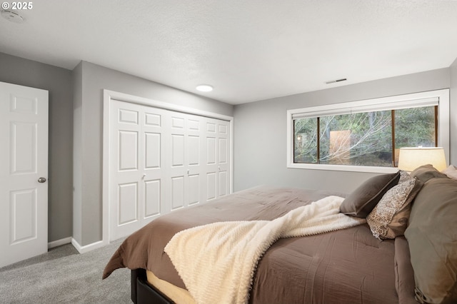 bedroom with a closet and light carpet