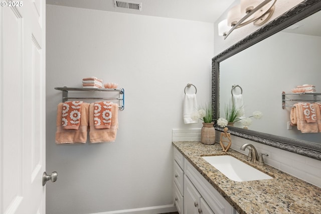 bathroom featuring vanity and decorative backsplash