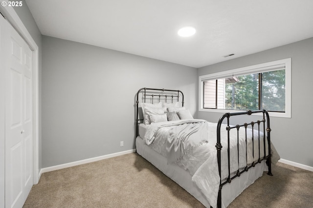 carpeted bedroom featuring a closet