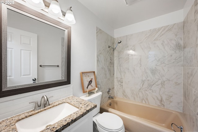 full bathroom featuring toilet, vanity, tasteful backsplash, and tiled shower / bath