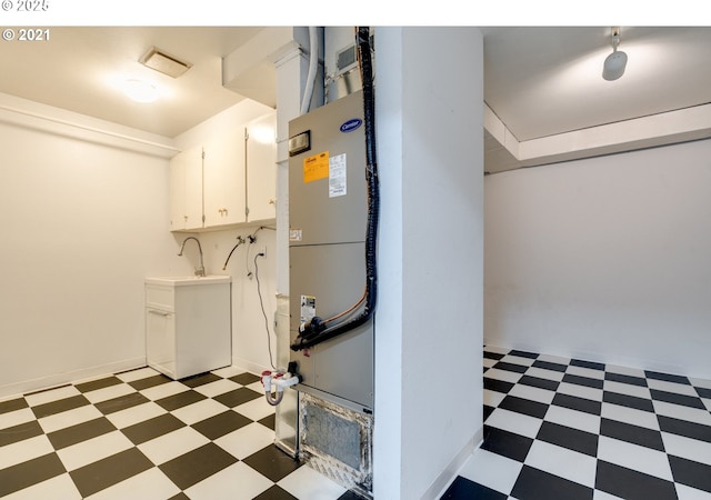 washroom featuring sink, washer hookup, and cabinets