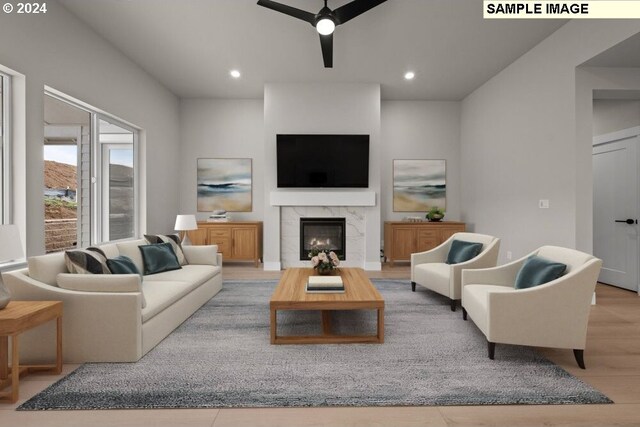 living room with ceiling fan and light hardwood / wood-style floors