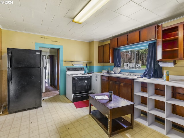 121 Jones Rd, Pe Ell, WA 98572 - kitchen with light tile flooring, black fridge, sink, and white electric range