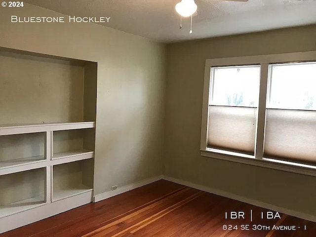 empty room featuring ceiling fan and hardwood / wood-style floors