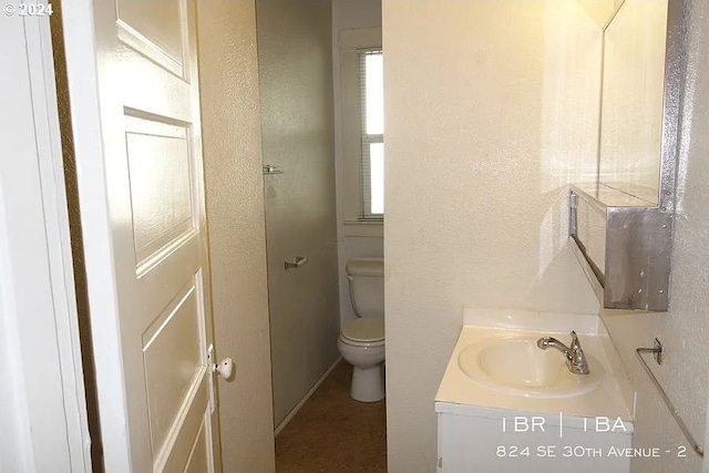 bathroom featuring vanity and toilet