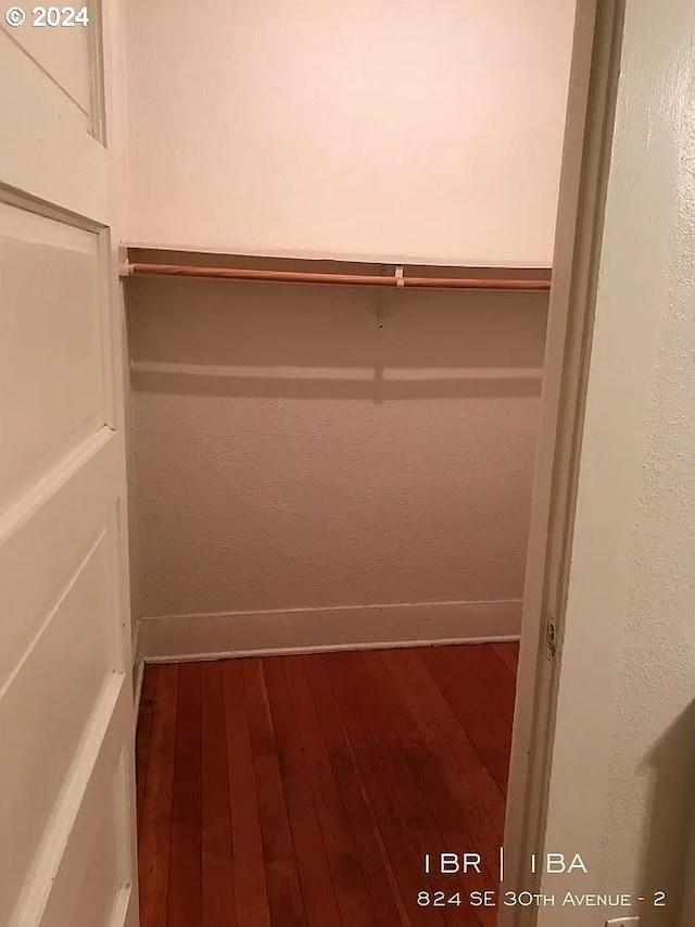 spacious closet featuring hardwood / wood-style flooring