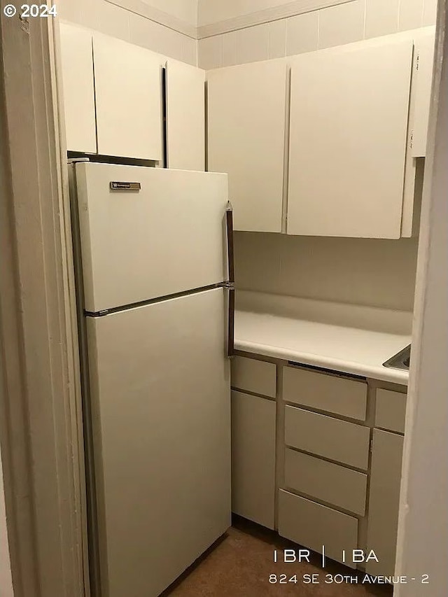 kitchen with white cabinetry and white refrigerator