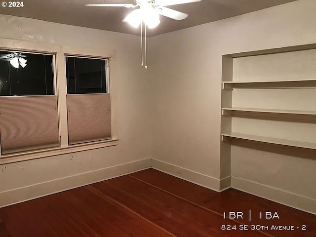 empty room with ceiling fan and dark hardwood / wood-style floors