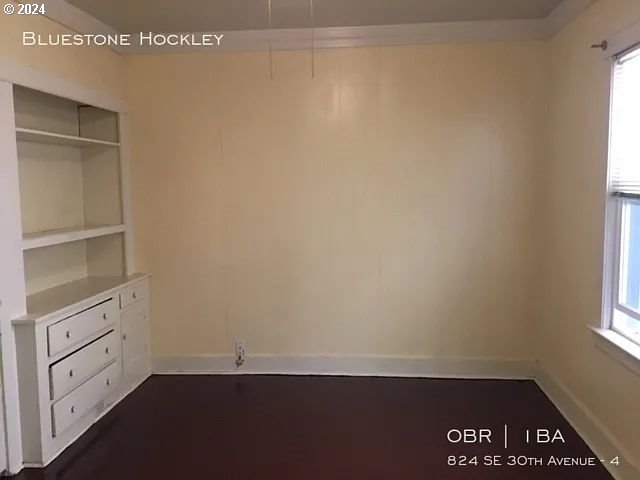 unfurnished bedroom featuring multiple windows