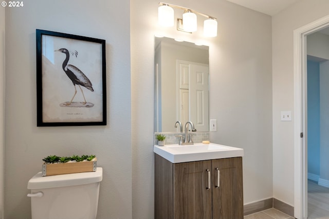 bathroom featuring toilet and vanity