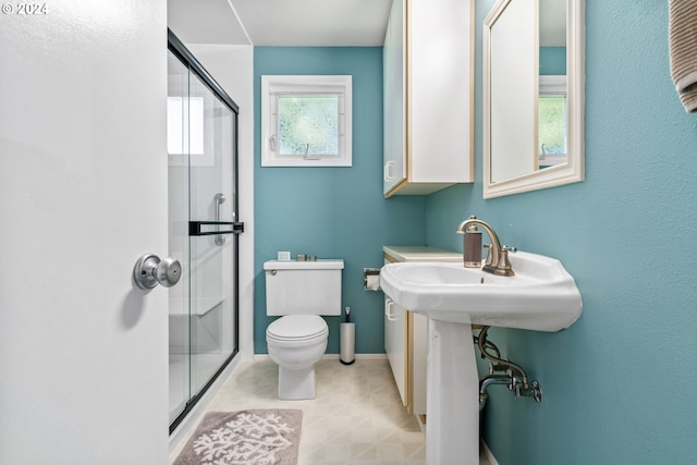 bathroom with an enclosed shower and toilet