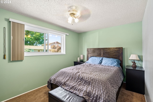 bedroom with carpet, ceiling fan, and a textured ceiling