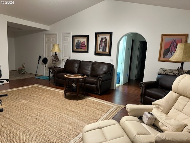 living room with dark hardwood / wood-style floors and vaulted ceiling